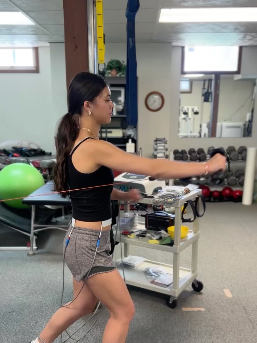 Athlete pressing against band resistance during a sports performance training session at Electric Rehab and Fitness in Missoula