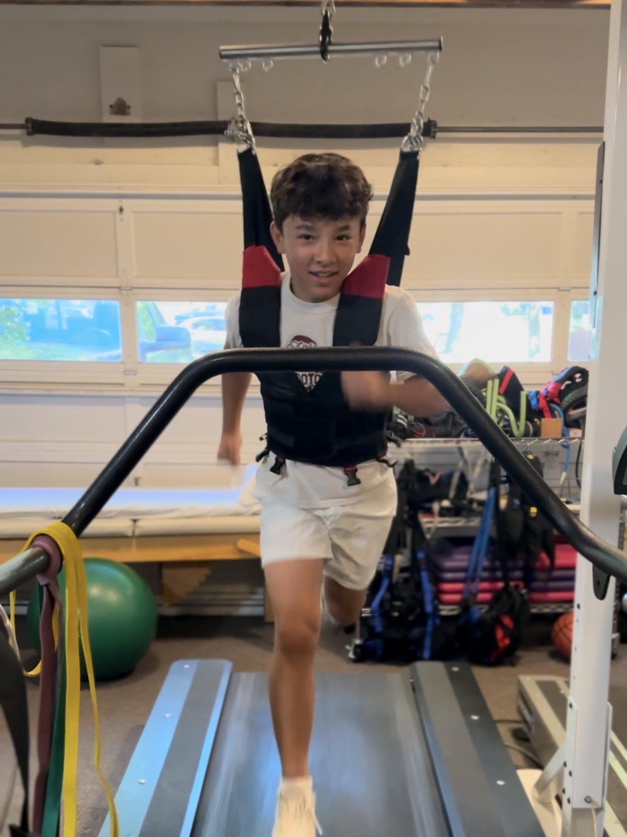 Middle school athlete running in the overhead harness on the high-speed treadmill in Missoula