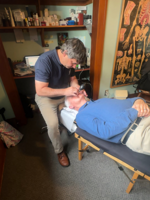 Dr. Clint Cordial performing Cranial Facial Release therapy on patient inside Electric Rehab & Fitness clinic in Missoula Montana.
